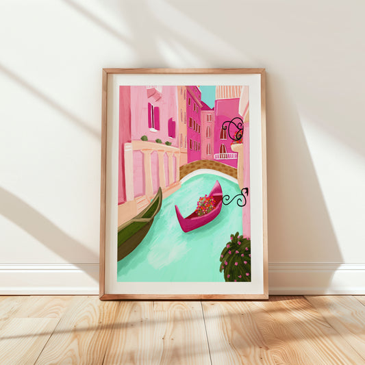Illustrated art print of a vibrant Venice canal scene featuring pastel pink buildings, a turquoise canal, and a magenta gondola adorned with flowers, framed by lush greenery and ornate iron balconies.