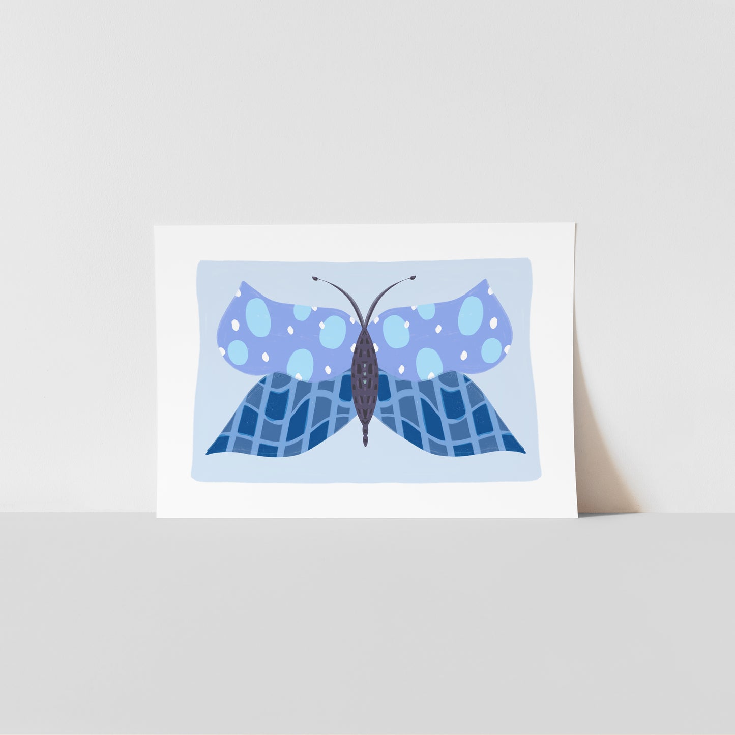 Art print with a blue butterfly design on a light blue background