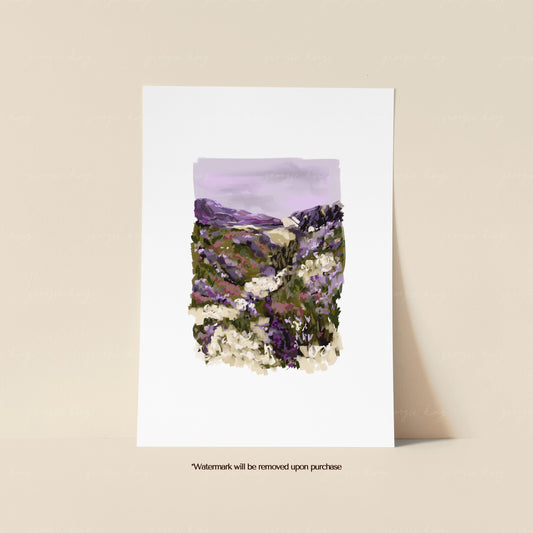 Heather hillside print featuring purple wildflowers, green hills and soft painterly countryside details

