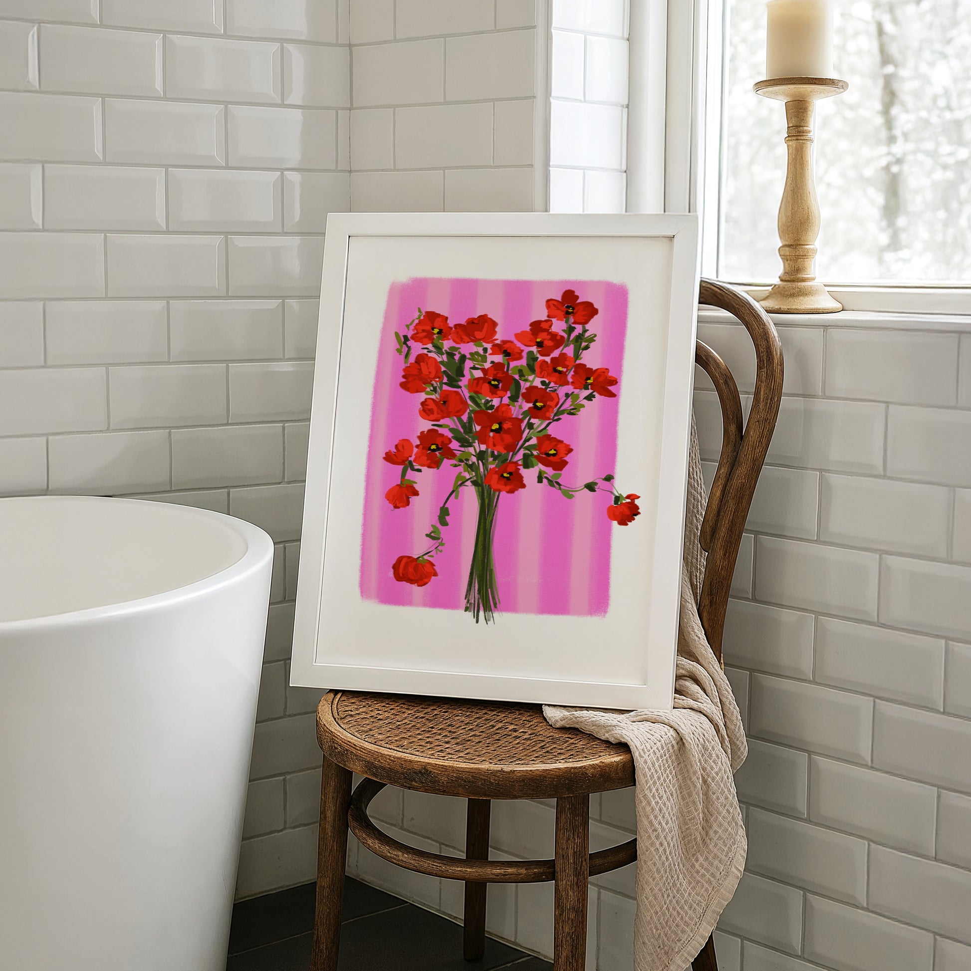 Bathroom wall art inspiration showing a poppy print on a wooden chair next to a freestanding tub and white tiles. A great example of botanical bathroom decor.