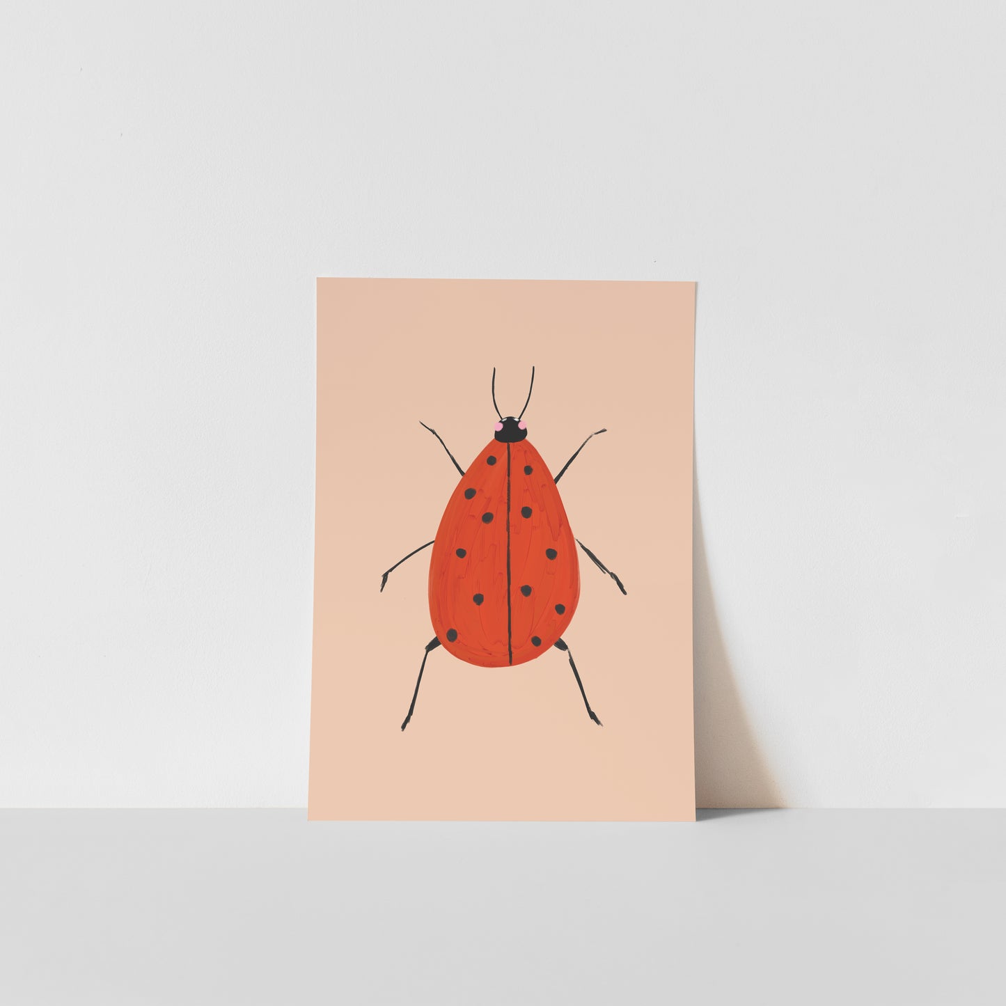 Art print with a red ladybird design on a beige background