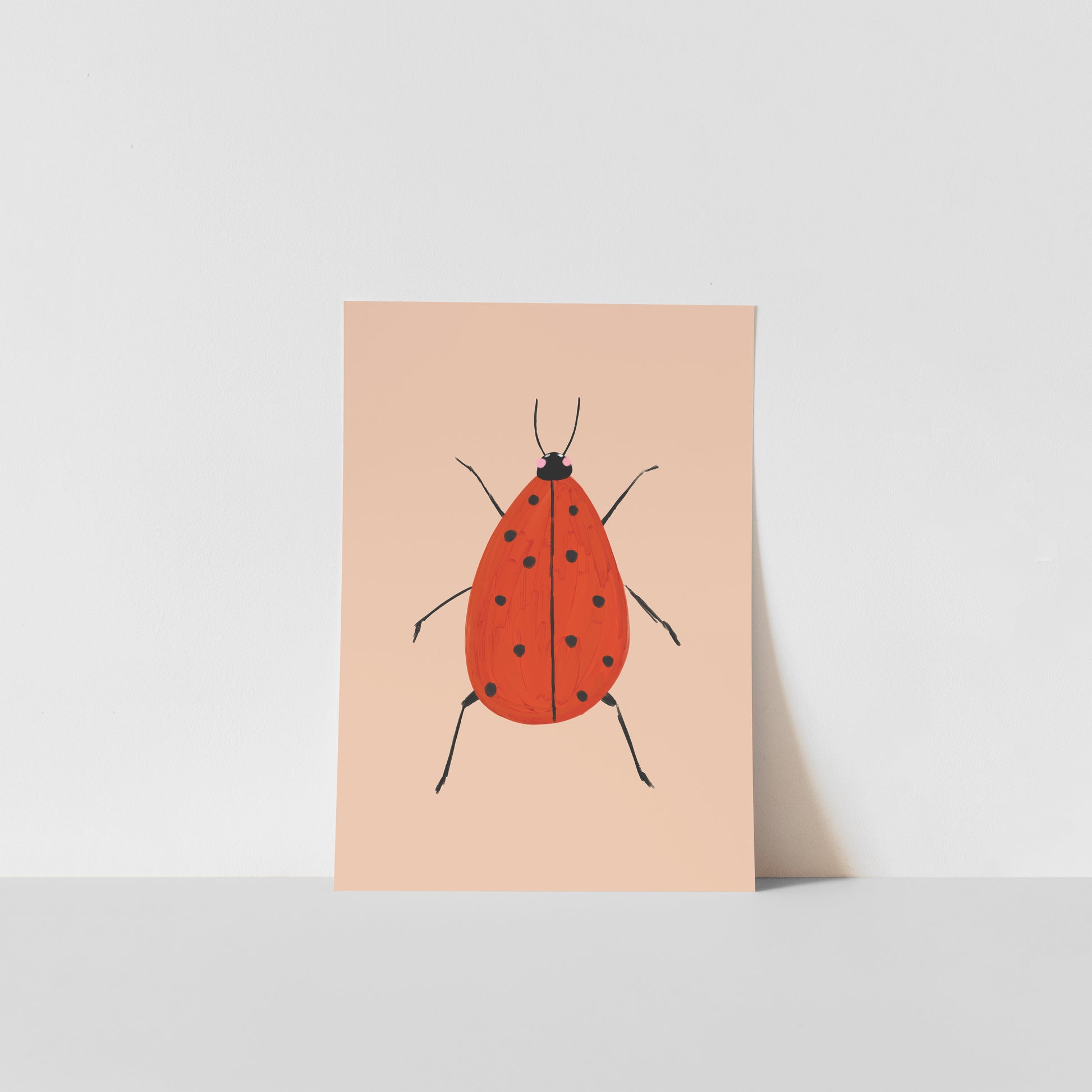 Art print with a red ladybird design on a beige background