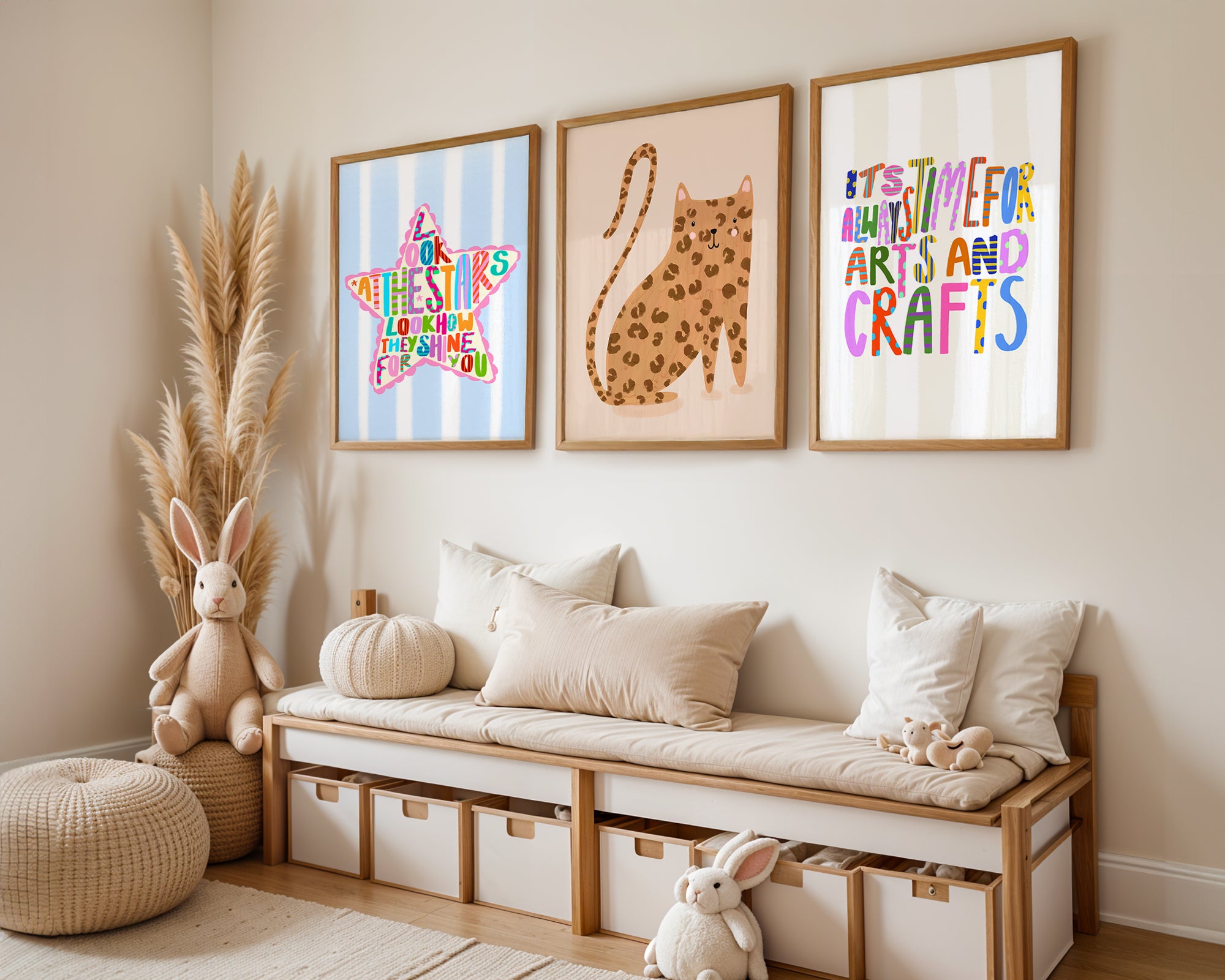 Neutral nursery with three children's wall art prints hanging.