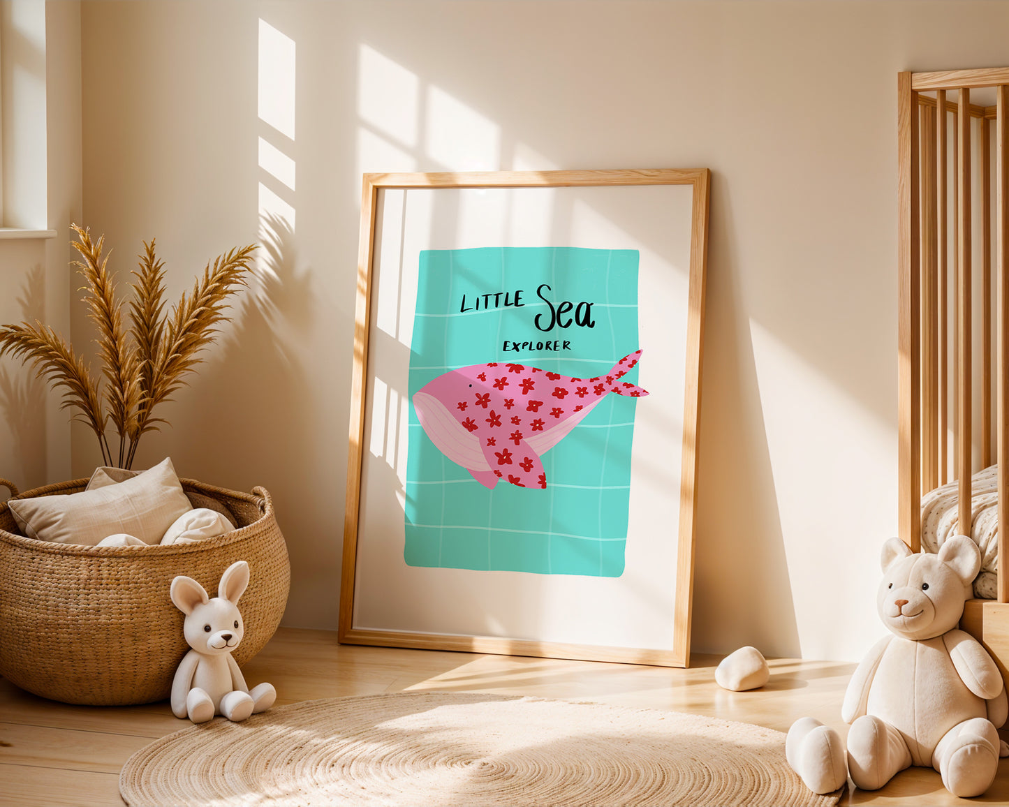 Framed artwork of a pink whale with floral-patterned body on a teal background, placed in a room with toys and kids decor.