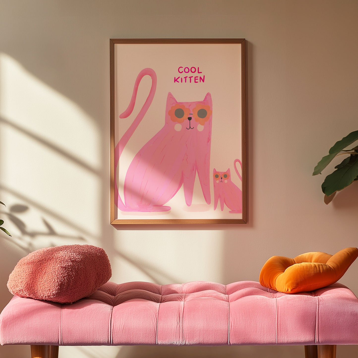 Framed artwork of a pink cat with sunglasses on a wall above a pink bench.