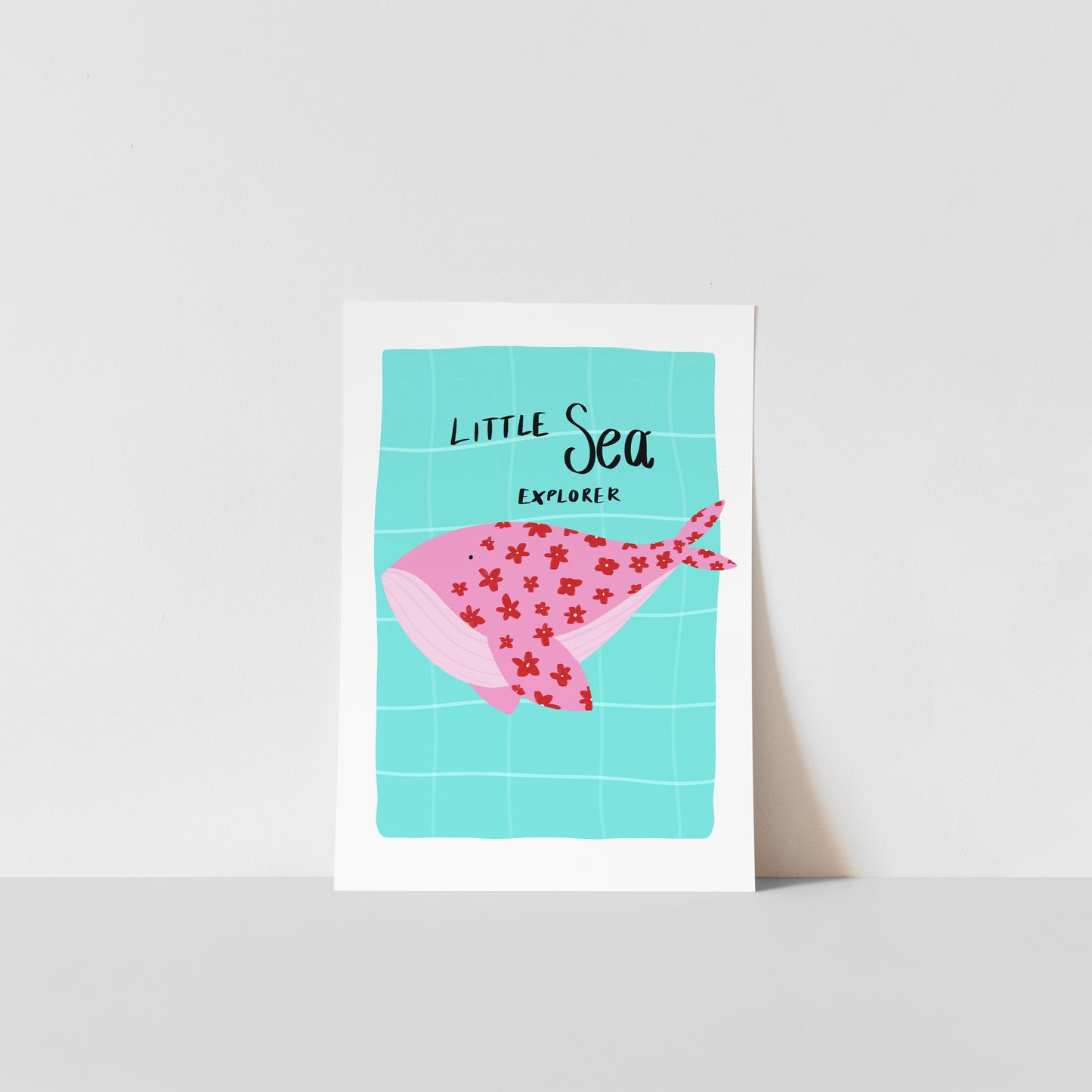 Art print with a pink whale illustration and 'Little Sea Explorer' text on a light blue background