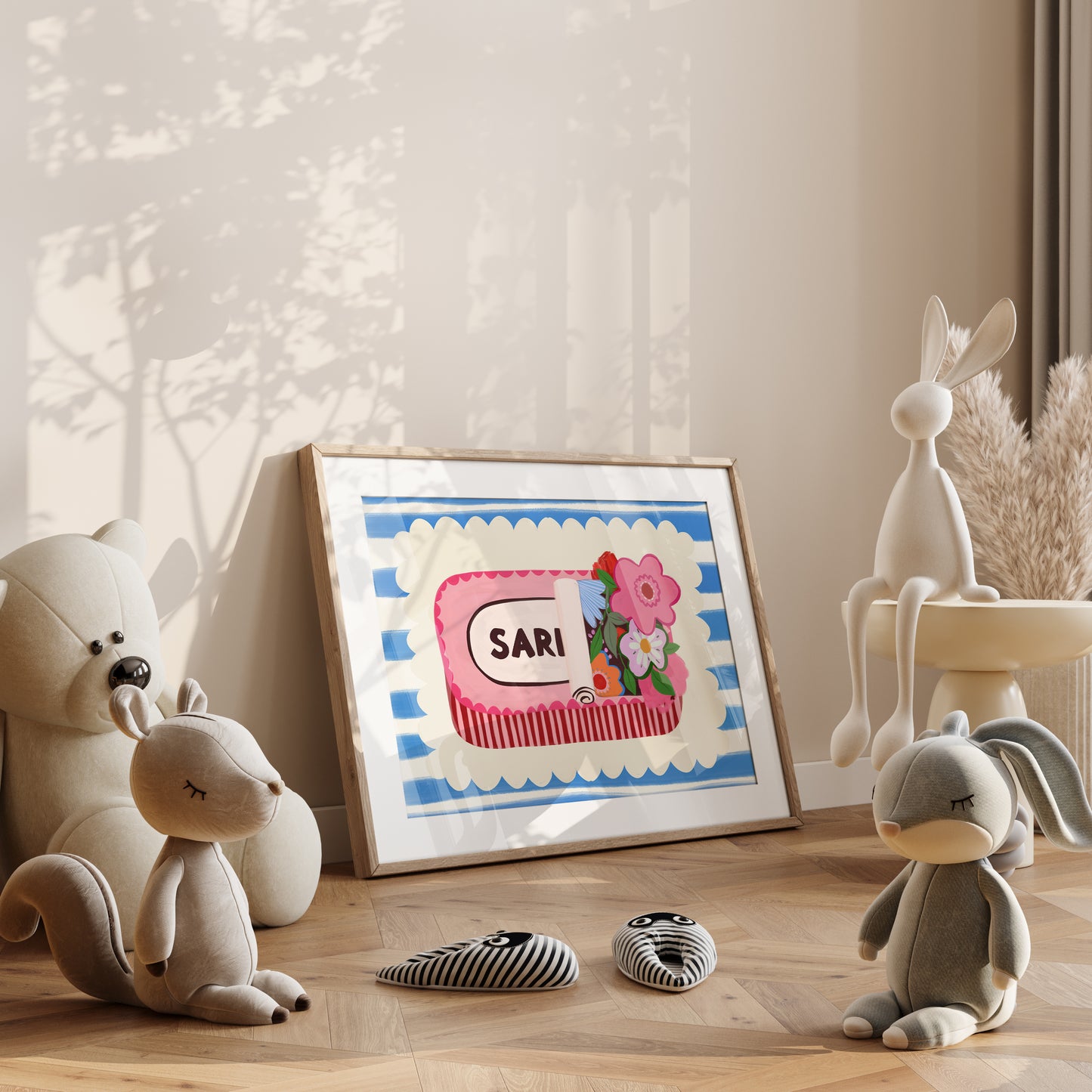 Framed artwork of a sardine tin on a shelf with plush toys and decorative items.
