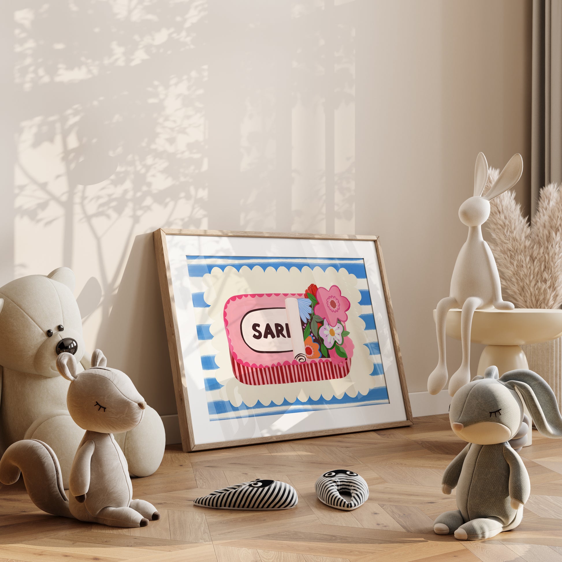 Framed artwork of a sardine tin on a shelf with plush toys and decorative items.