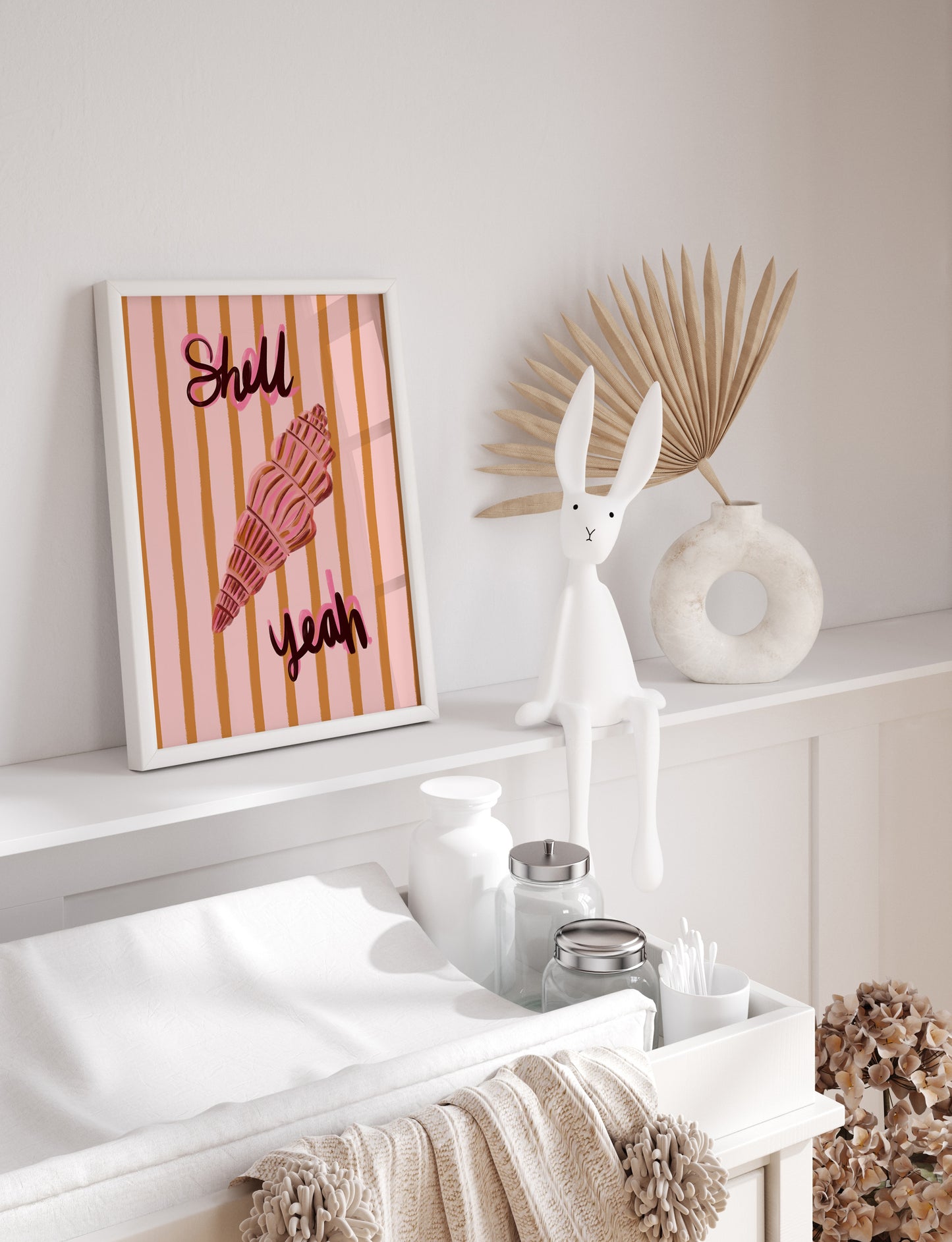 Decorative shelf with a rabbit sculpture, striped shell art print, and decorative items.