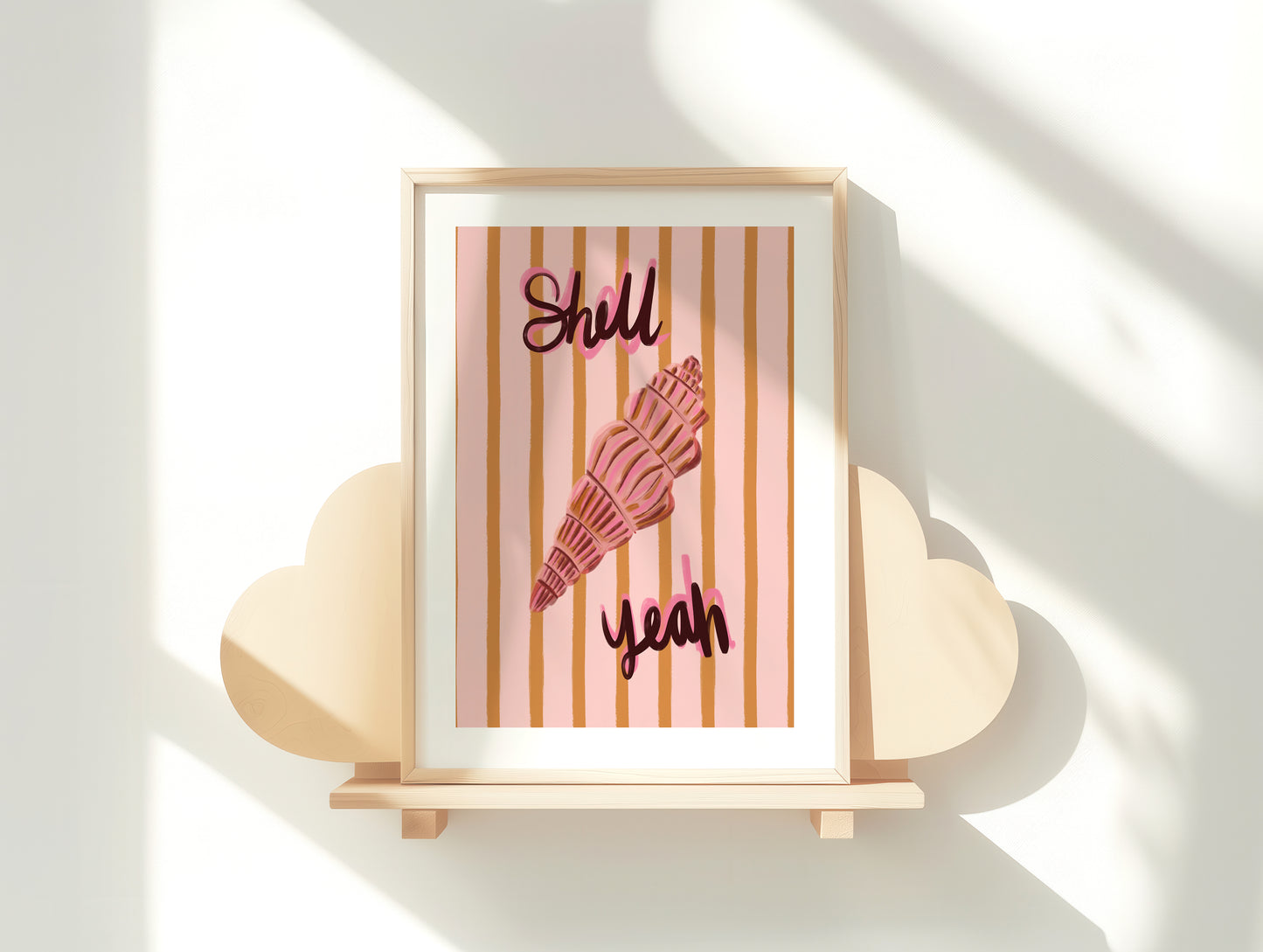 Framed artwork with a pink shell and text on a white surface